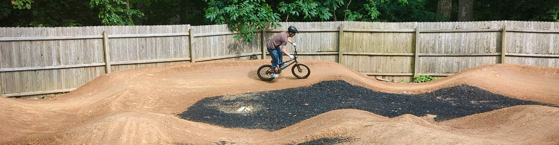 Backyard pumptrack by Sticks & Stones Trailco
